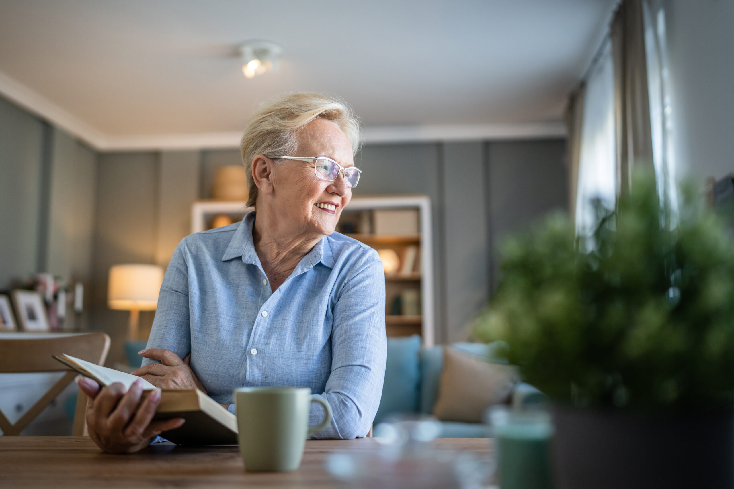 Senior Woman Mature Caucasian Female Read Book At Home Wear Eyeglasses